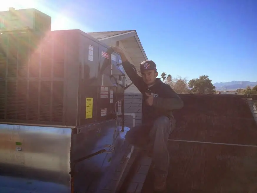 HVAC technician performing HVAC Inspection on a rooftop unit in Pasadena